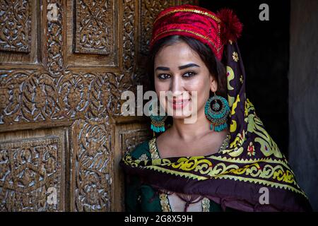 Portrait of Uzbek woman in traditional clothes in Khiva, Uzbekistan Stock Photo