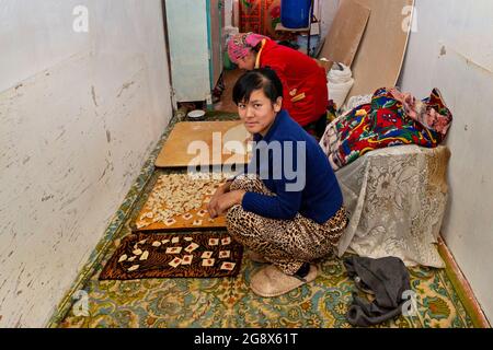 Uzbek women making local ravioli known as "Manti" in Nukus, Uzbekistan Stock Photo