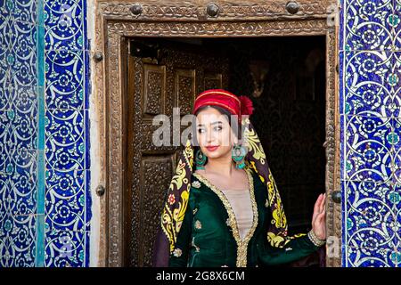 Portrait of Uzbek woman in traditional clothes in Khiva, Uzbekistan Stock Photo