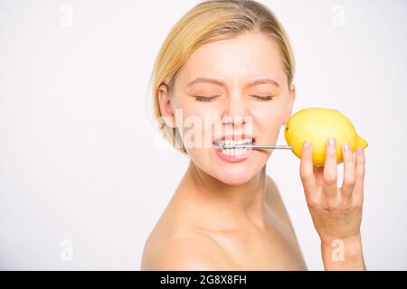 Lemon with hobnail natural battery. Recharge your body vitamins. Girl drink fresh juice whole lemon fruit. Energy source and vitality. Battery concept Stock Photo