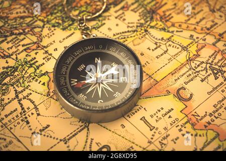 Compass on a tourist map, travel and journey concept background Stock Photo