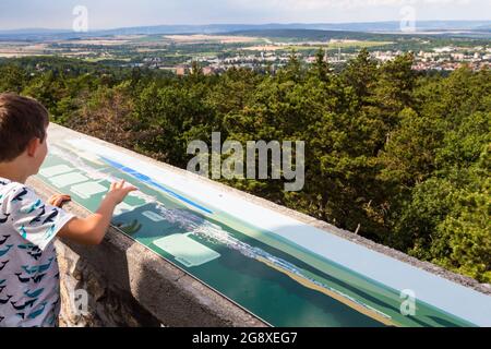 Boy child looking at view from Karoly-kilato (lookout tower), Soproni-hegyseg, Sopron, Hungary Stock Photo