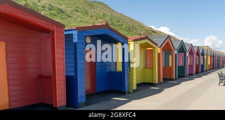 Long row of colourful beach huts in Saltburn Stock Photo