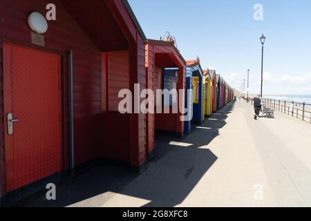 Long row of colourful beach huts in Saltburn Stock Photo