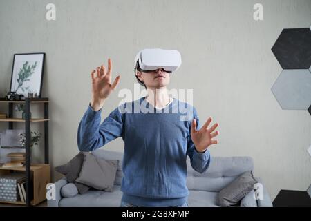 Man is using virtual reality headset. Concept of virtual reality, simulation, gaming and future technology. Stock Photo