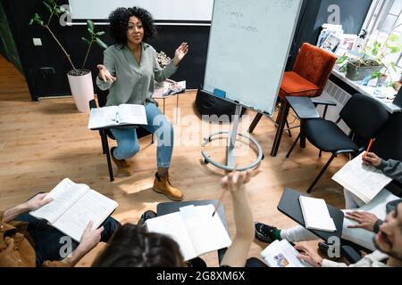 Multiethnic group of students studying together in the classroom Stock Photo