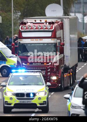 File photo dated 23/10/19 of police escorting a container lorry in which the bodies of 39 Vietnamese men, women and children were found, away from the Waterglade Industrial Park in Grays, Essex, following their discovery. Romanian Alexandru-Ovidiu Hanga, 29, of Hobart Road in Essex, a member of a people-smuggling gang linked to the deaths of the 39 Vietnamese men, women and children has been ordered to pay the bereaved families £3,000. Issue date: Friday July 23, 2021. Stock Photo
