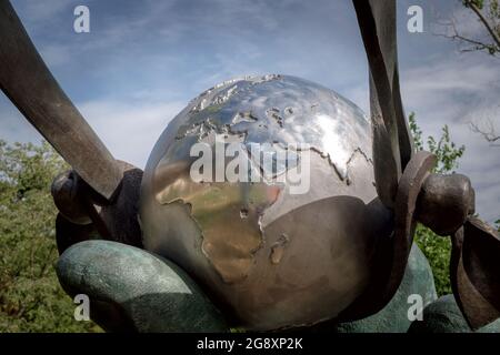 Close up view of the Earth globe inside a slingshot , concept for ecology awareness in the sculpture made by Lorenzo Quinn at Forte Marghera, Venice Stock Photo