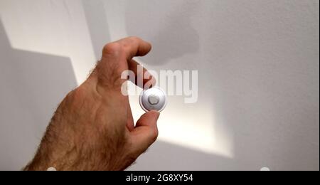 Man pov looking at AirTag by Apple Computers Inc Stock Photo