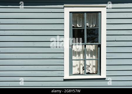 Old painted gray and white window with horizontal clapboards Stock Photo