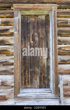 Exterior of an old weathered wood log cabin door Stock Photo