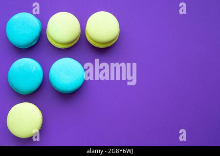 macaroni cookies in the upper left corner on a purple bright background Stock Photo