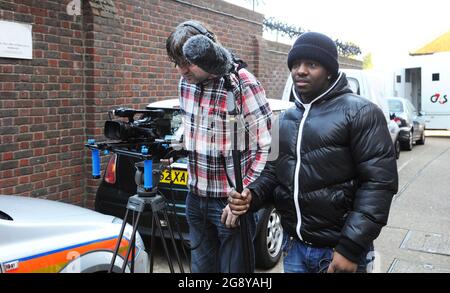 Film Crew Lining Up a Shot for a Scene Take. Stock Photo