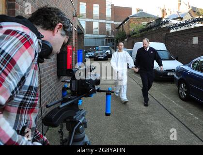 Film Crew Filming a Scene With Actors. Stock Photo