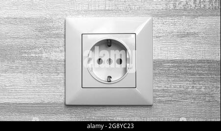 Electric socket on gray wall close-up, EU socket in modern interior Stock Photo