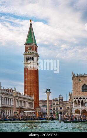 Iconic view of St Mark's campanile and columns by waterfront of piazzetta on St Mark square, Grand Canal, Venice, Italy. Travel destination, must-see Stock Photo