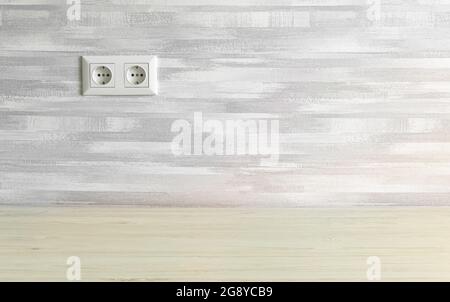 Simple home interior with power socket on gray wall, copy space Stock Photo