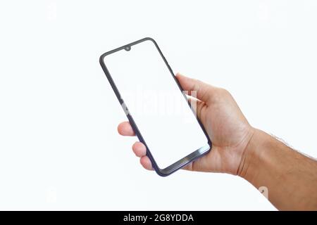 Man hand holding smartphone with blank white screen. Phone isolated on white background for mockup. Copy space. Clipping path. Stock Photo