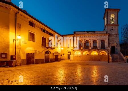 Piazza San Benedetto square in the historic center of Norcia, Italy, illuminated by evening lights Stock Photo