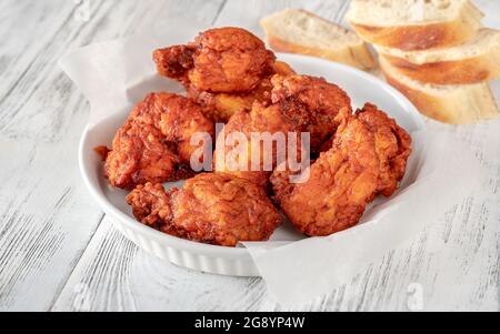 Nashville Hot Chicken covered in cayenne pepper sauce Stock Photo