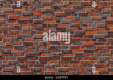 Wall of artistically designed bricks. Wall decor Stock Photo