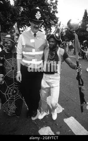 Handsworth Carnival in Birmingham Uk 1988 PC Colin Pearson with revellers Stock Photo