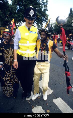 Handsworth Carnival in Birmingham Uk 1988 PC Colin Pearson with revellers Stock Photo