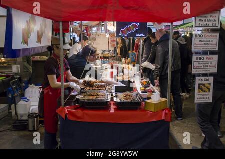 USA. 29th Oct, 2017. Female vendors cook and serve food at the Brick Lane Market, a major shopping district and outdoor market for secondhand goods in Tower Hamlets, East London, United Kingdom, October 29, 2017. (Photo by Smith Collection/Gado/Sipa USA) Credit: Sipa USA/Alamy Live News Stock Photo