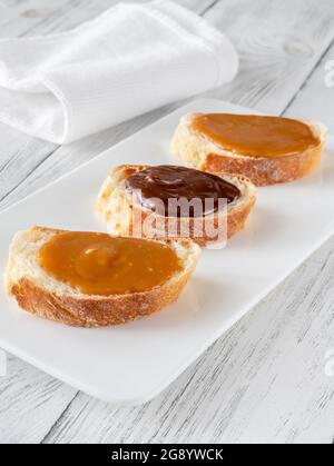 Sandwiches with different types of caramel on the serving plate Stock Photo