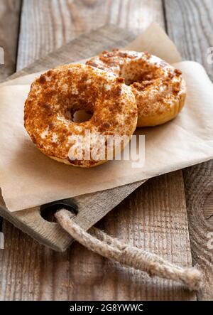 Two donuts on the wooden board Stock Photo