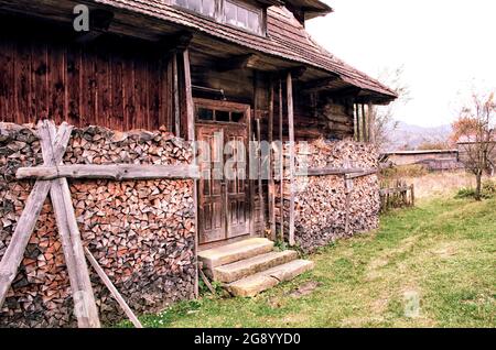 Background of splitted, dried and stacked firewood. Bunch of wood. Stock Photo