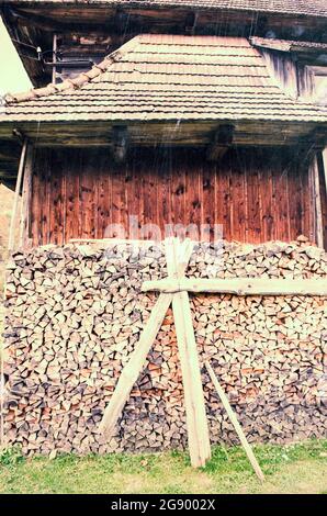 Background of splitted, dried and stacked firewood. Bunch of wood. Stock Photo
