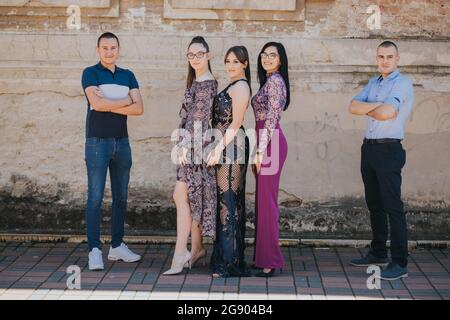 Group of young Bosnian females posing with males standing on both sides Stock Photo
