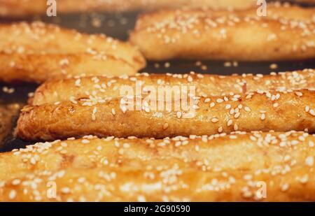 Bakery products. Buns with sesame seeds on a dark background. Loaf Stock Photo