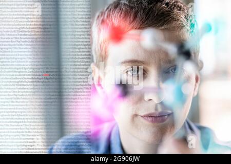 Female professional behind molecular structure at office Stock Photo