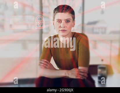 Female entrepreneur sitting on desk with network security icon and light beams at office Stock Photo