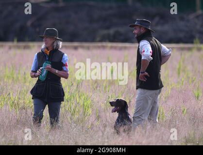 Ragley Hall, Warwick, Warwickshire, UK. 23rd July, 2021. The Game Fair Exhibition Show; Ben Barrett of Scotland and his dog Aytee Kalimar during the Hunt Point Retrieve HPR International competition Credit: Action Plus Sports/Alamy Live News Stock Photo