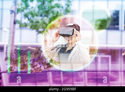 Female professional using virtual reality headset Stock Photo