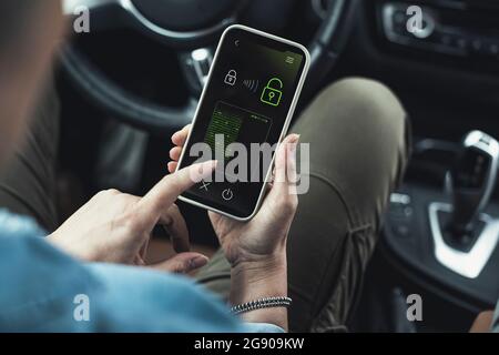 Woman unlocking data lock on smart phone in car Stock Photo