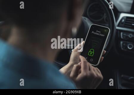 Woman unlocking data protection lock on smart phone in car Stock Photo