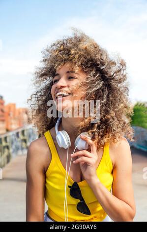 Happy Afro woman with tousled curly hair Stock Photo
