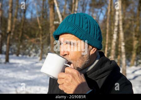 Senior man drinking coffee on sunny day Stock Photo