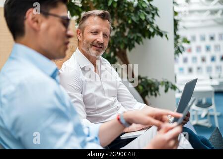 Male professional team using digital tablet at office Stock Photo