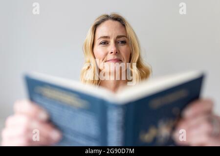 Mature woman reading book at home Stock Photo