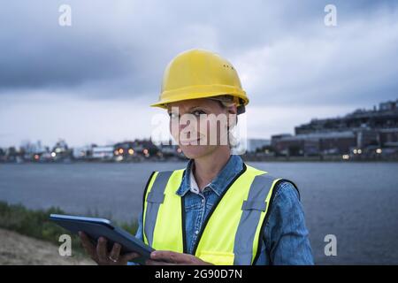 Female logistic worker holding digital tablet Stock Photo