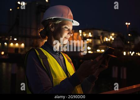 Mature female professional using digital tablet at night Stock Photo