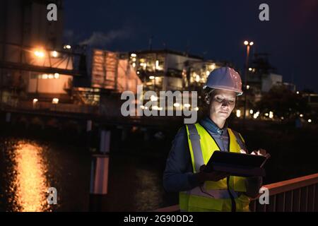 Mature female professional using digital tablet at night Stock Photo