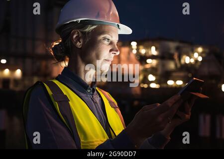 Female professional using digital tablet at night Stock Photo