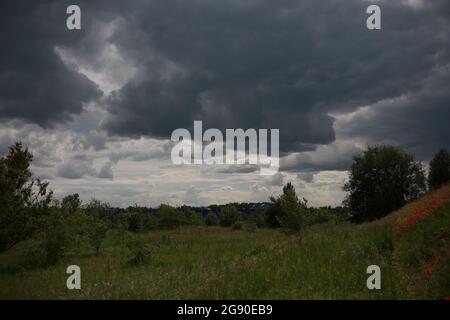 cloudy blue rainy sky over the field Stock Photo