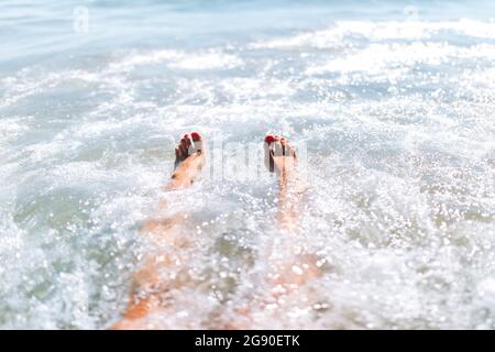 Young woman enjoying swimming in sea on sunny day Stock Photo